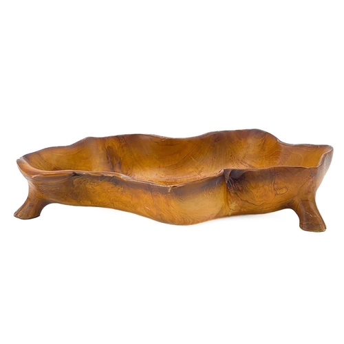 23 - A fruit wood carved bowl. Shaped as vine leaf on four short supports, width 47cm. Small chips, wear ... 