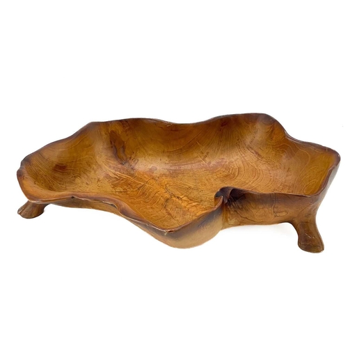 23 - A fruit wood carved bowl. Shaped as vine leaf on four short supports, width 47cm. Small chips, wear ... 