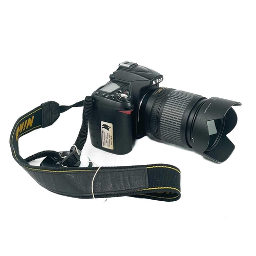 233 - A Nikon D90 camera. Fitted with Nikon AF-S NIKKOR 18-105mm lens, together with an AF Micro NIKKOR 60... 