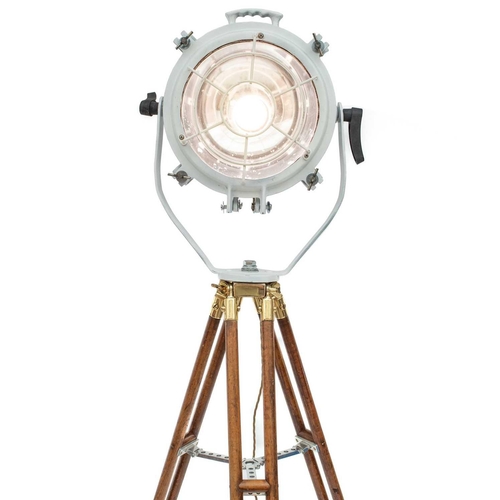 235 - A ship's cargo deck light on a tripod stand. White painted, with a metal grille, the stained beech t... 