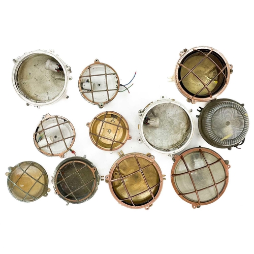 236 - A collection of marine bulkhead circular light fittings. Largest diameter 21cm. (box)