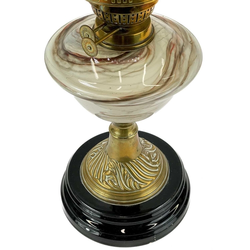 244 - A Victorian brass oil lamp with marble glass reservoir. Yellow glass shade, height 59cm.