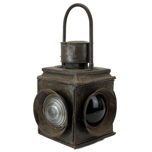 245 - A late 19th century tinned railway level crossing lamp. Fitted two red and two clear glass lenses, w... 