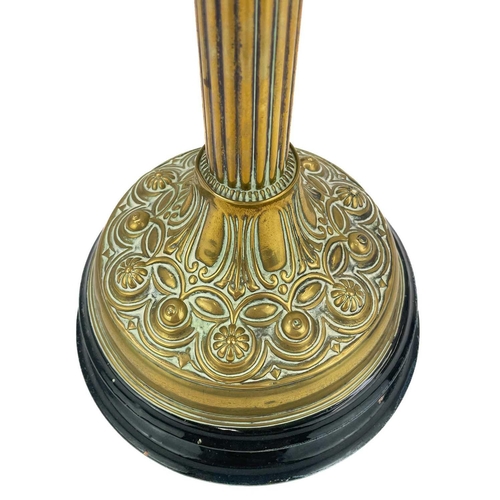 247 - A Victorian brass oil lamp with etched glass shade. On a circular base, with a moulded and painted g... 