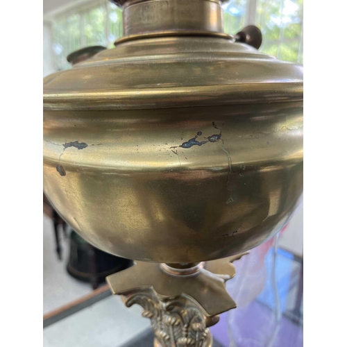 251 - A Victorian brass oil lamp with an etched cranberry glass shade. With brass corinthian style base, b... 