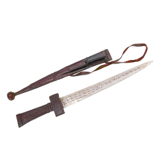 274 - A Tuareg Takouba type short sword. Leather clad and with ball terminal, the sheath fitted an additio... 