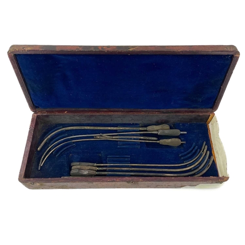 318 - A cased set of catheters. Some with ebony handles in a velvet lined leather case.