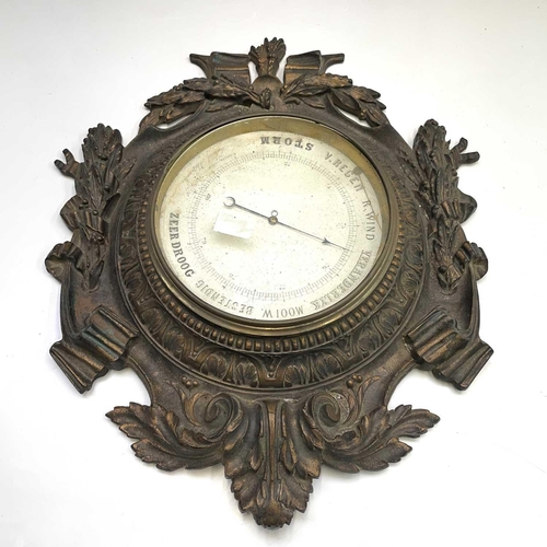 320 - A Dutch aneroid barometer. Late 19th century, the dial signed Cossa, in an ornate gilt decorated cas... 