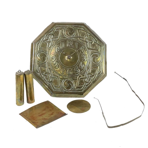 336 - An Arts and Crafts repousse decorated brass faced wall clock. With Arabic numerals and broad Celtic ... 