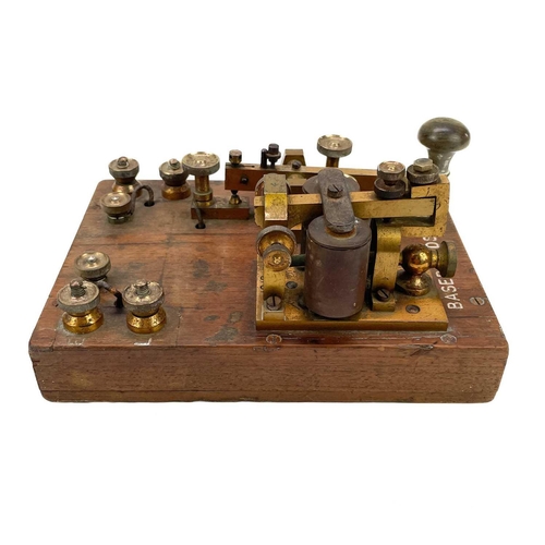 338 - A brass G.P.O telegraph Key serial number 6787. Mounted on mahogany with Broad Arrow and Basebords. ... 