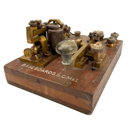 338 - A brass G.P.O telegraph Key serial number 6787. Mounted on mahogany with Broad Arrow and Basebords. ... 