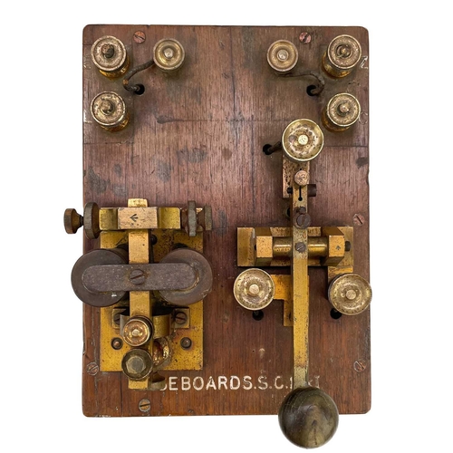 338 - A brass G.P.O telegraph Key serial number 6787. Mounted on mahogany with Broad Arrow and Basebords. ... 