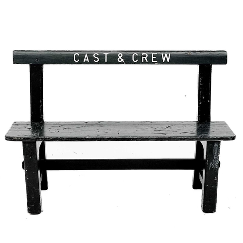 350 - A painted wood bench. CAST and CREW, height 85cm width 123cm.