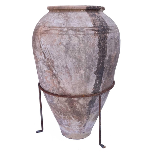 353 - A terracotta olive jar. With a wire tripod stand, overall height 69cm.