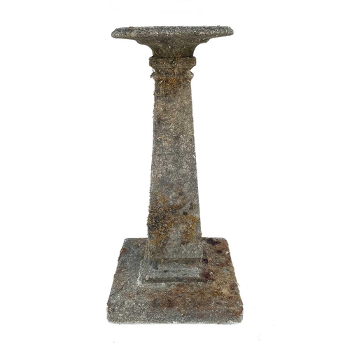 356 - A cast concrete bird bath. With square tapering column on stepped base, height 85cm.