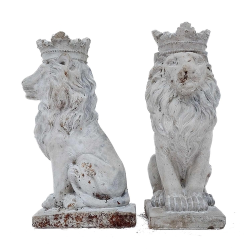 375 - A pair of reconstituted stone lions. Height 35cm, depth 18.5cm, width 13cm.