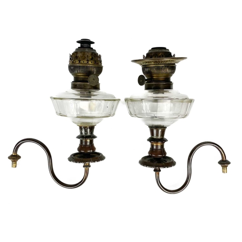 38 - A Victorian wall mounted brass oil lamp. With moulded glass shade, length 35cm, together with a pair... 