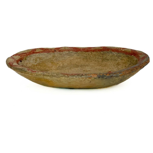 415 - A primitive pottery bowl. Probably South American, painted with a stylised fish with a red glaze, wi... 