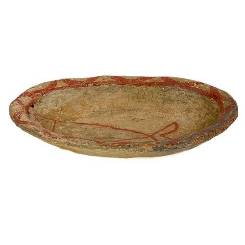 415 - A primitive pottery bowl. Probably South American, painted with a stylised fish with a red glaze, wi... 