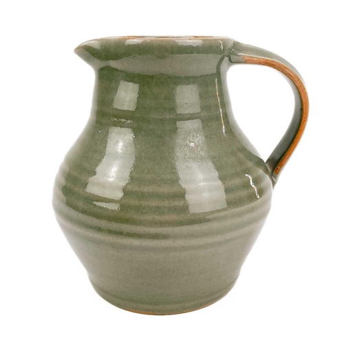 416 - A Crowan Pottery celadon jug by Harry Davis. Impressed marks, height 17cm.