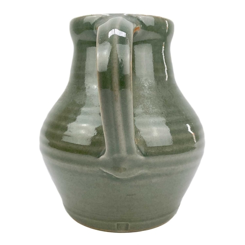 416 - A Crowan Pottery celadon jug by Harry Davis. Impressed marks, height 17cm.