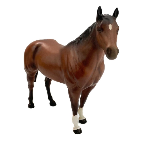 426 - A Beswick pottery quarter horse. Height 21.5cm together with two Beswick Pottery foals. (3)