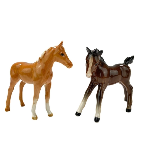 426 - A Beswick pottery quarter horse. Height 21.5cm together with two Beswick Pottery foals. (3)