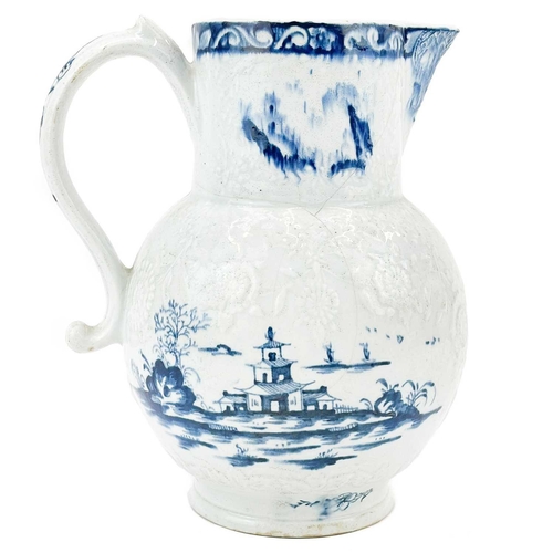 431 - A large Lowestoft blue and white floral moulded jug. Decorated with a pagoda in a landscape, 2 mark ... 