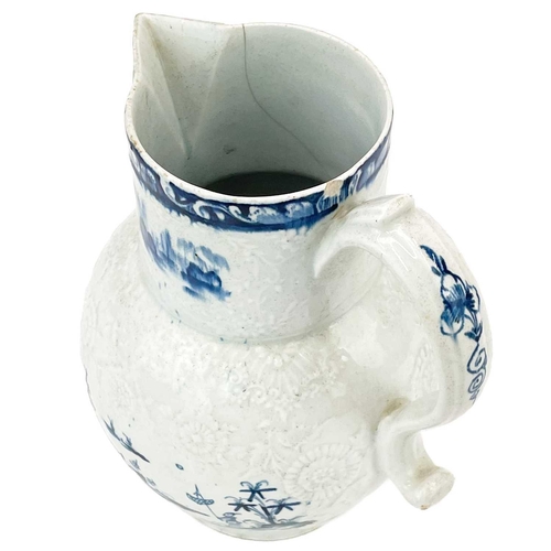 431 - A large Lowestoft blue and white floral moulded jug. Decorated with a pagoda in a landscape, 2 mark ... 