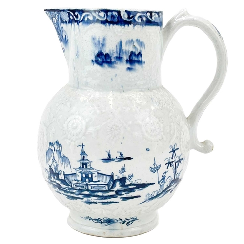 431 - A large Lowestoft blue and white floral moulded jug. Decorated with a pagoda in a landscape, 2 mark ... 