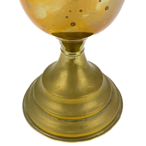 44 - A Victorian brass oil lamp with a moulded green glass shade. With a brass oil reservoir and a domed ... 