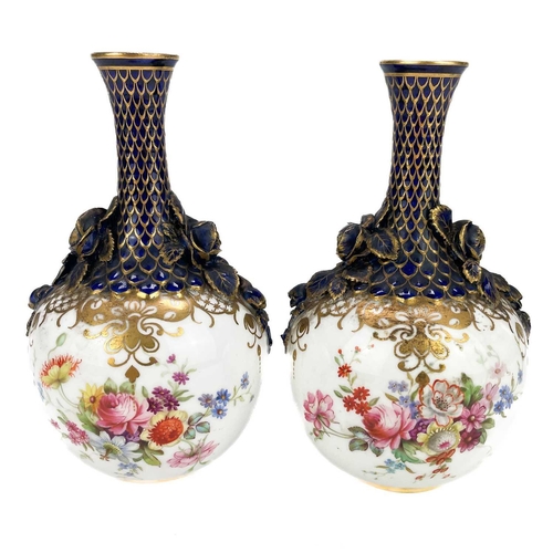 441 - A pair of Royal Worcester bottle vases with moulded floral and scale design highlighted in gilt. Dec... 