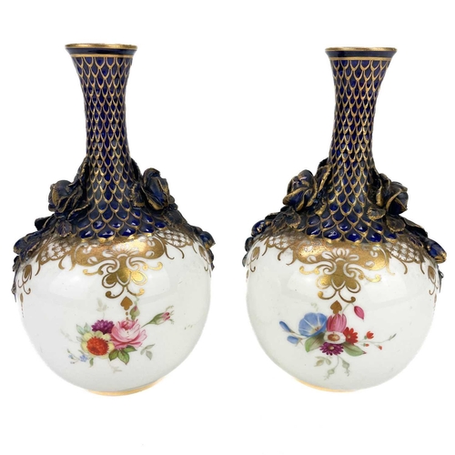 441 - A pair of Royal Worcester bottle vases with moulded floral and scale design highlighted in gilt. Dec... 