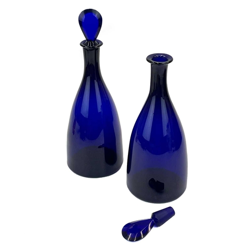 459 - A pair of George III Bristol blue glass Indian Club form decanters. With bevelled edge lozenge stopp... 