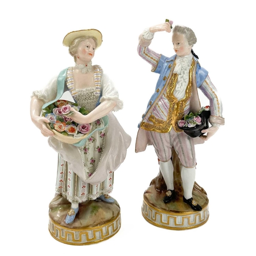 463 - A pair of Meissen figures of flower sellers. Late 19th century, each in 18th century costume, on cir... 