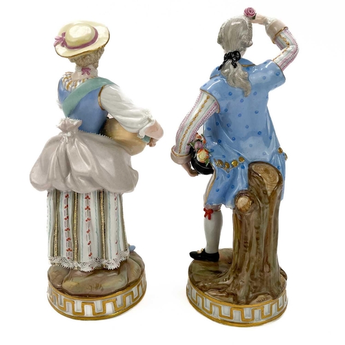 463 - A pair of Meissen figures of flower sellers. Late 19th century, each in 18th century costume, on cir... 