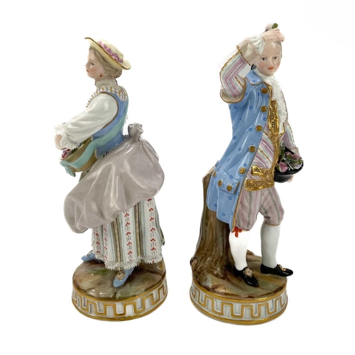 463 - A pair of Meissen figures of flower sellers. Late 19th century, each in 18th century costume, on cir... 