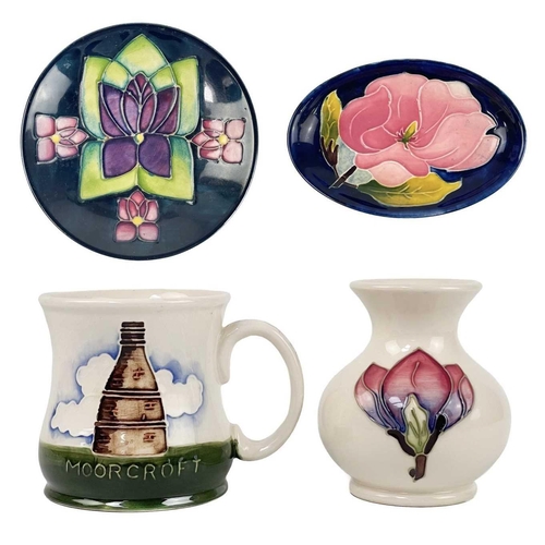 495 - A Moorcroft pottery mug, a vase and two dishes. The mug dated 1986, height 9cm, the vase tube-lined ... 