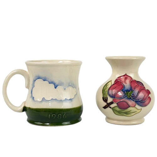 495 - A Moorcroft pottery mug, a vase and two dishes. The mug dated 1986, height 9cm, the vase tube-lined ... 