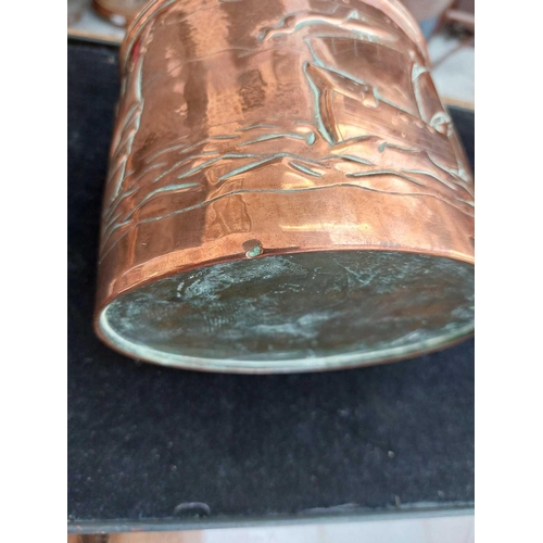 5 - A Newlyn copper oval tea caddy. The pull off cover with loop handle and two shells, the main body re... 