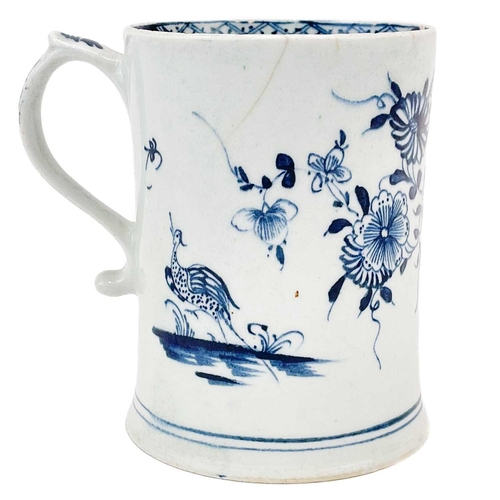 501 - Lowestoft porcelain tankard. Decorated in blue and white with flora and fauna in a rocky landscape, ... 