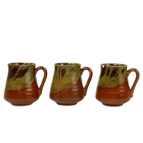 502 - A collection of Lamorna pottery. To include six cups with saucers, a milk jug, a small cup, a platte... 