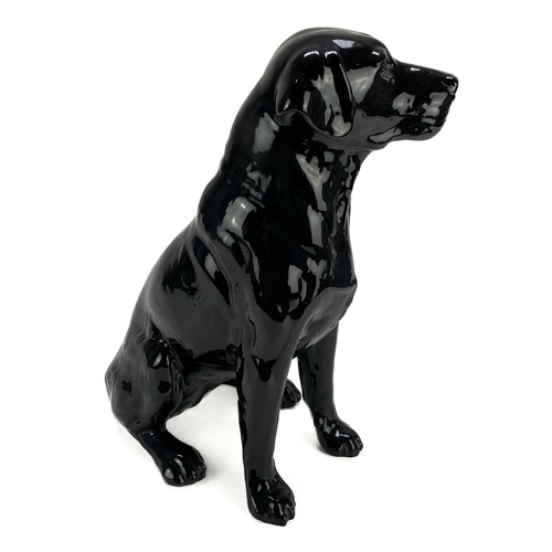 506 - A Beswick fireside seated black Labrador. Number 2314, height 33.5cm.