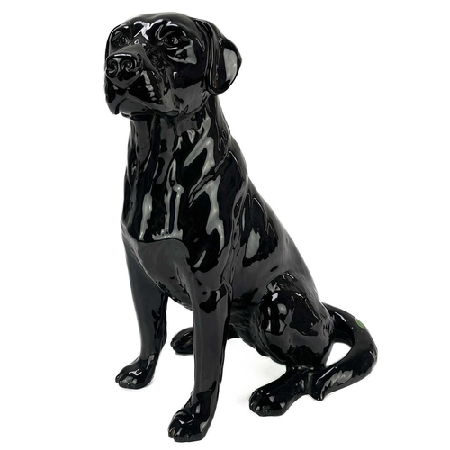 506 - A Beswick fireside seated black Labrador. Number 2314, height 33.5cm.