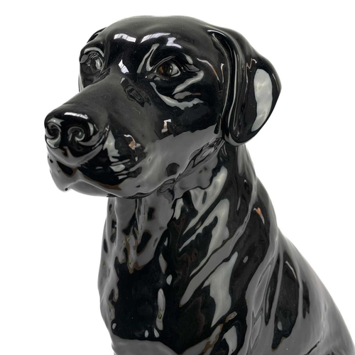 506 - A Beswick fireside seated black Labrador. Number 2314, height 33.5cm.