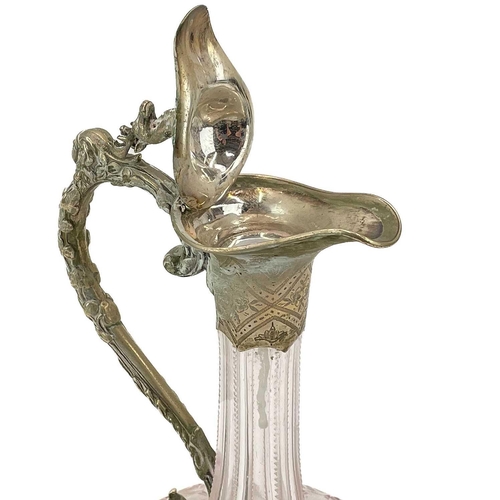 509 - A Victorian cut glass and silver plated claret jug. The hinged cover with stag head finial, the body... 