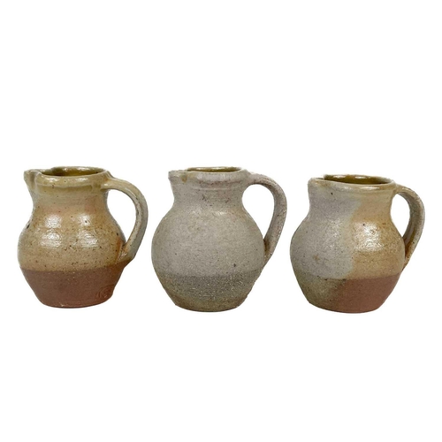 511 - A collection of Seth Cardew studio pottery. To include a teapot 14 cm high, three small cream jugs 8... 