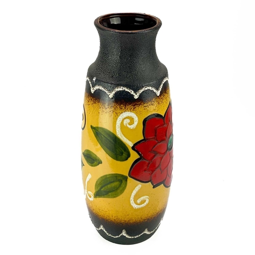 519 - A West German tall Lava jug. Decorated with a flower, height 47cm.