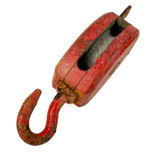 52 - A red painted ship's block and hook. Height 40cm.