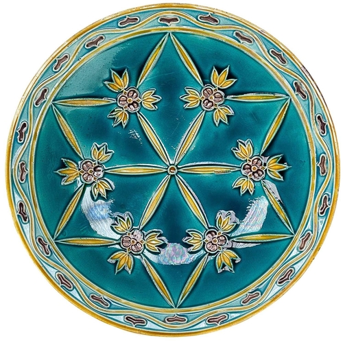 535 - A Minton secessionist plate. The turquoise ground with tube-lined floral decoration, printed mark, d... 